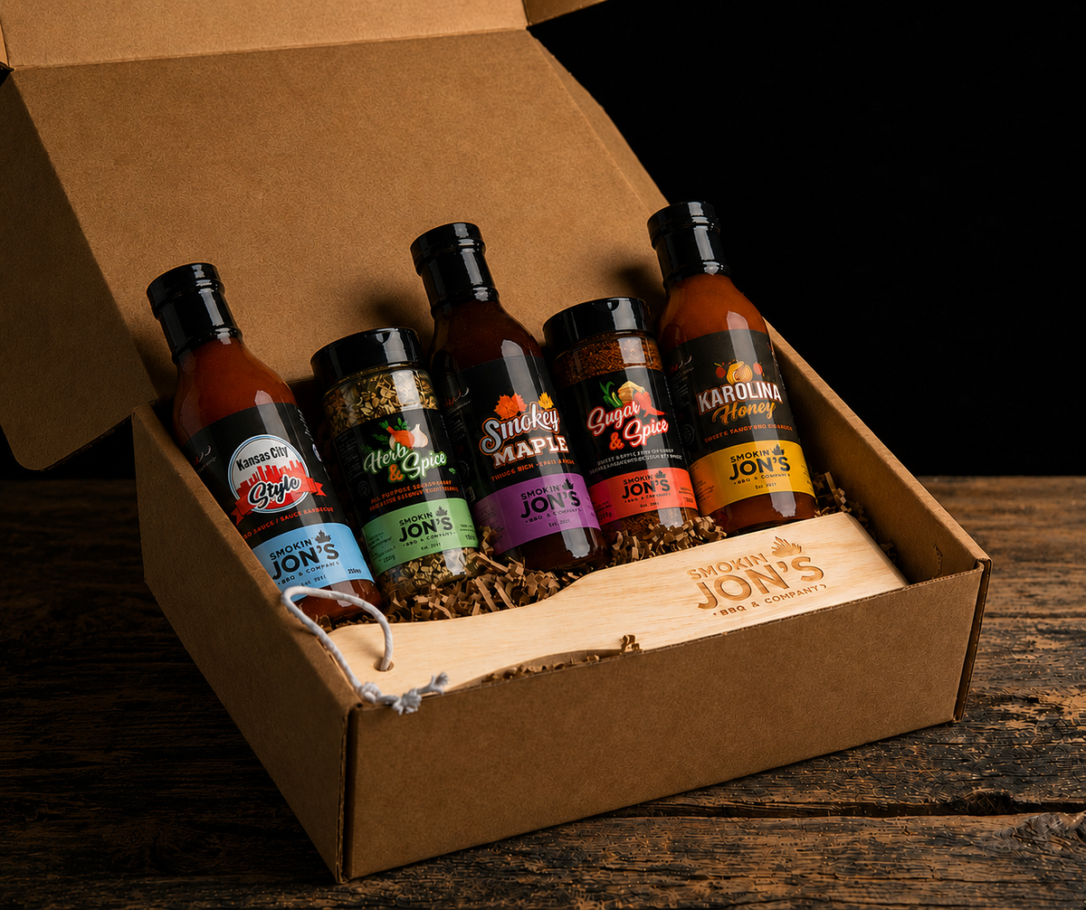 Collection of Jon's Hot Sauces in a cardboard box on a wooden surface.